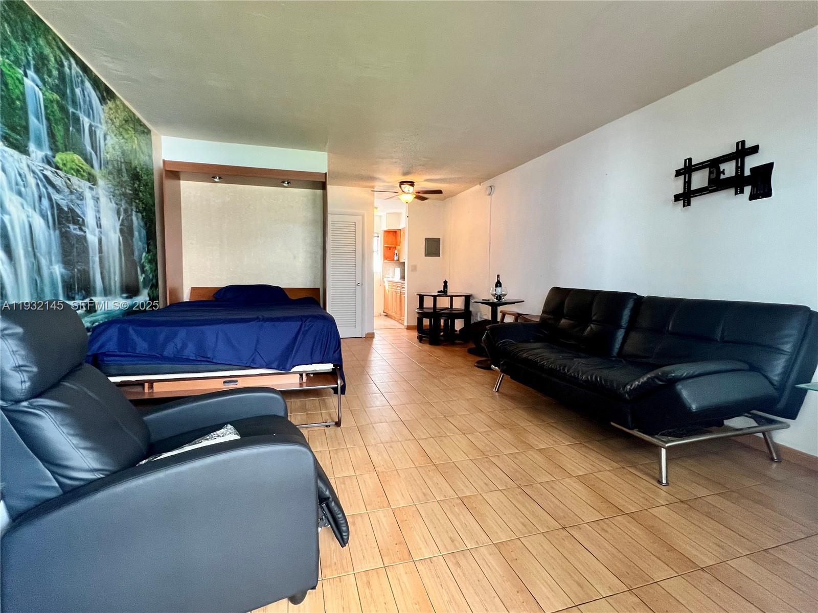 7434 Harding Avenue, Unit 8 Miami Beach, FL 33141 - Photo 2 of 3 a living room with a couch and a rug