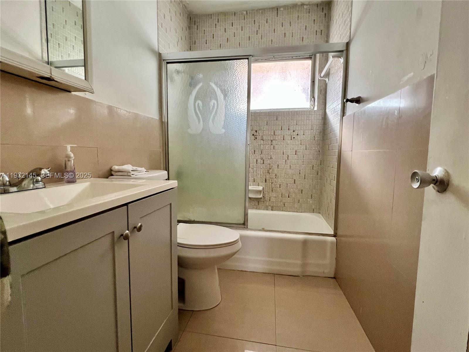 7434 Harding Avenue, Unit 8 Miami Beach, FL 33141 - Photo 3 of 3 a bathroom with a sink a toilet and shower