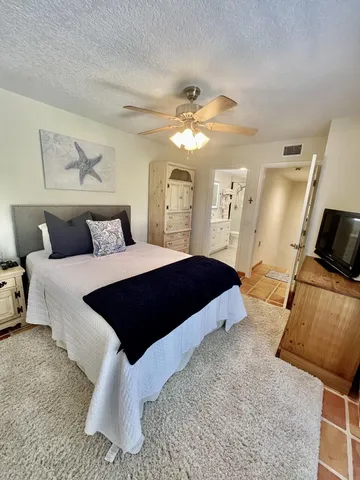 a bedroom with a large bed and a couch