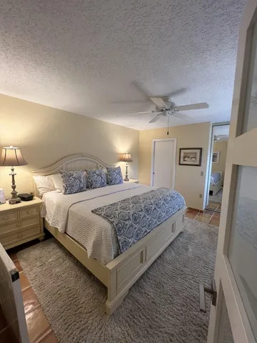 a bedroom with a bed and a large mirror