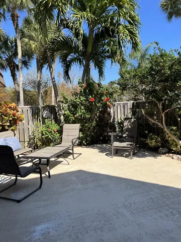 a view of backyard with a table and chairs and a fire pit
