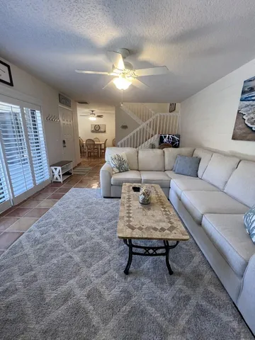 a living room with furniture and a chandelier