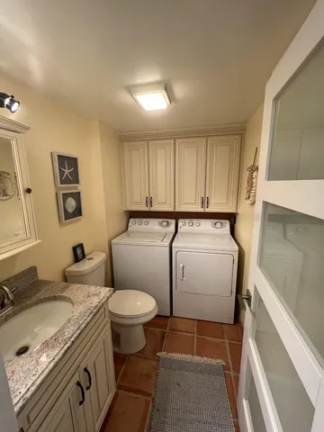 a bathroom with a sink toilet and a mirror