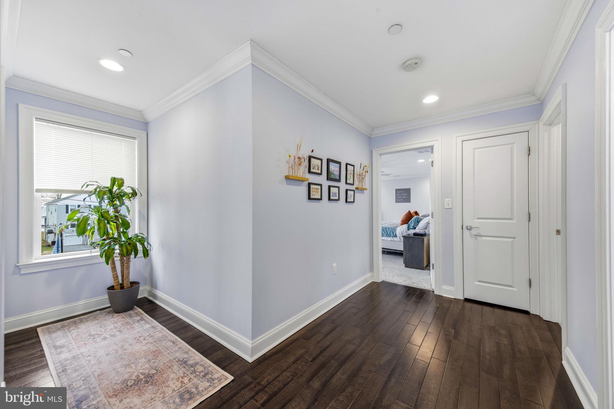 3628 Bay Drive Baltimore, MD 21220 - Photo 30 of 72 a view of a hallway with wooden floor and a living room