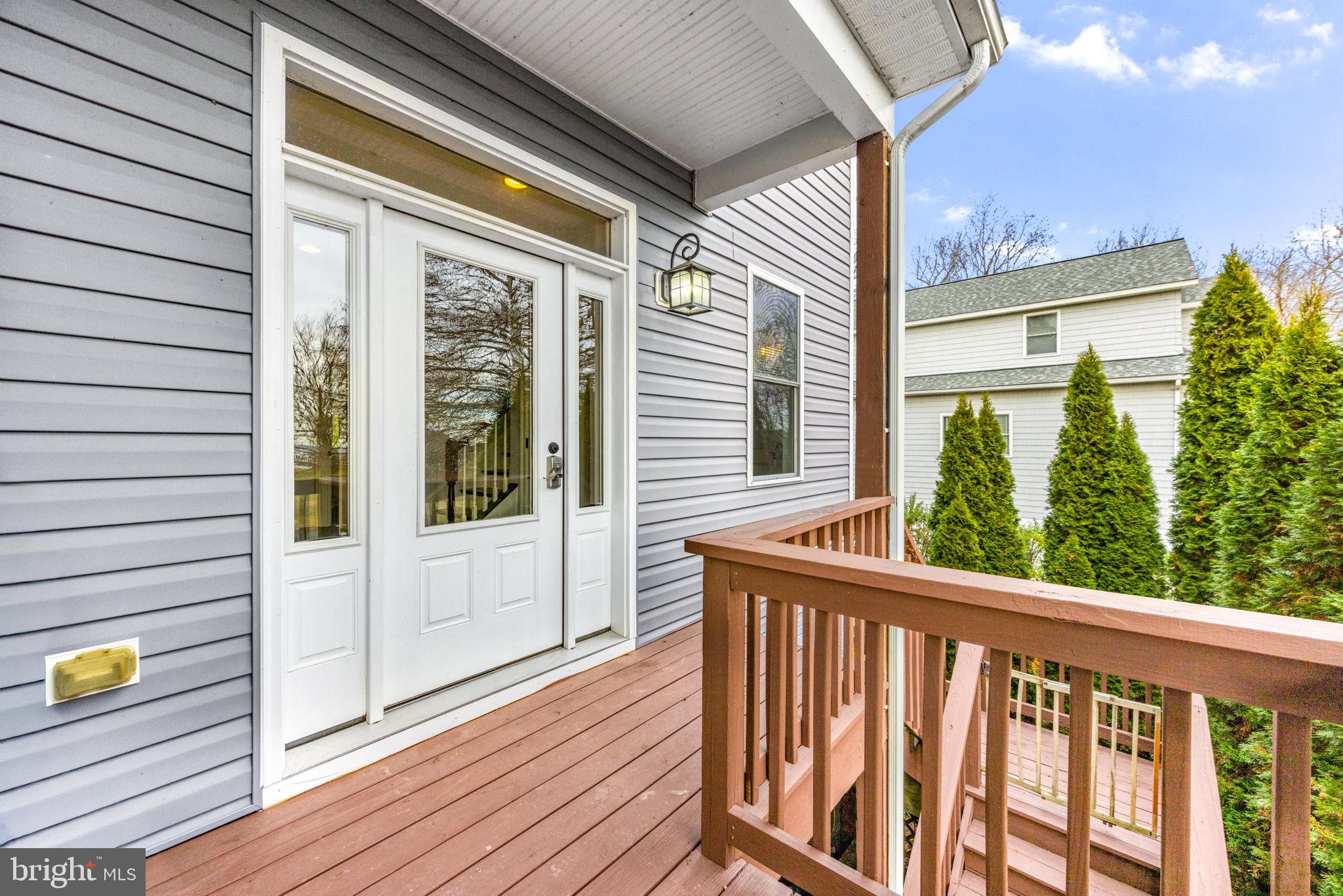 3628 Bay Drive Baltimore, MD 21220 - Photo 53 of 72 a view of a balcony with wooden floor and iron fence