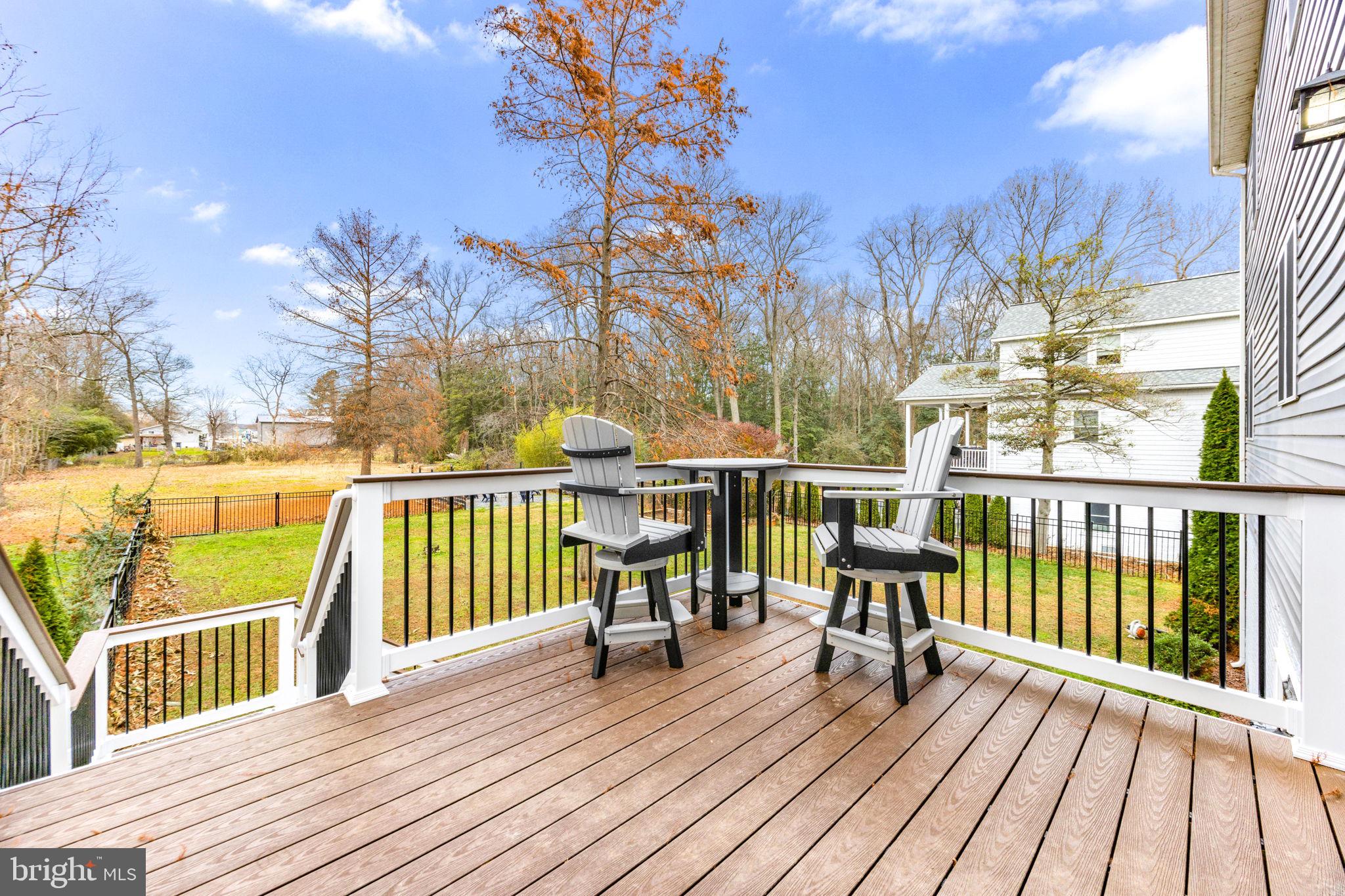 3628 Bay Drive Baltimore, MD 21220 - Photo 62 of 72 a view of a balcony with chairs wooden floor and fence