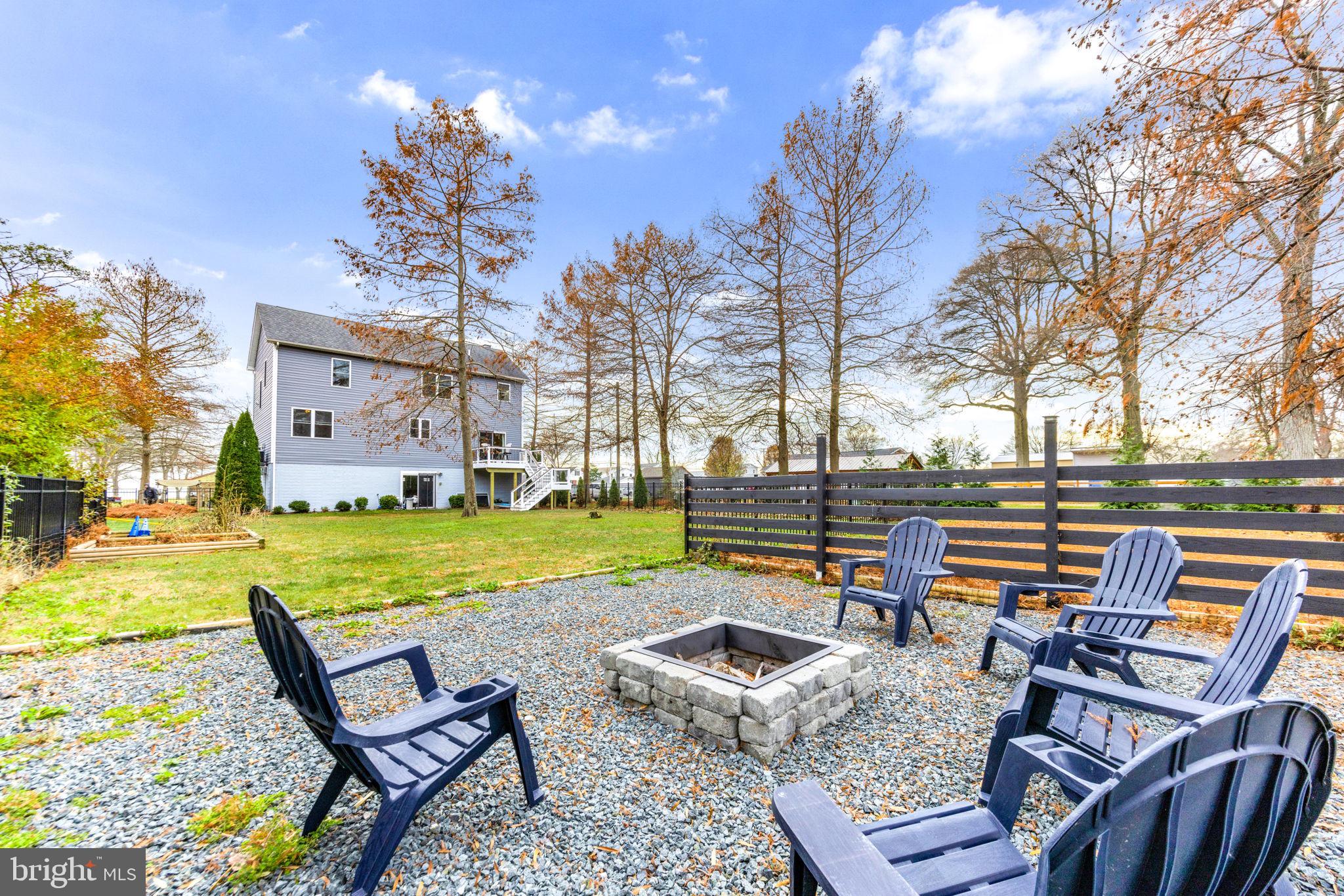 3628 Bay Drive Baltimore, MD 21220 - Photo 65 of 72 a backyard of a house with barbeque oven table and chairs