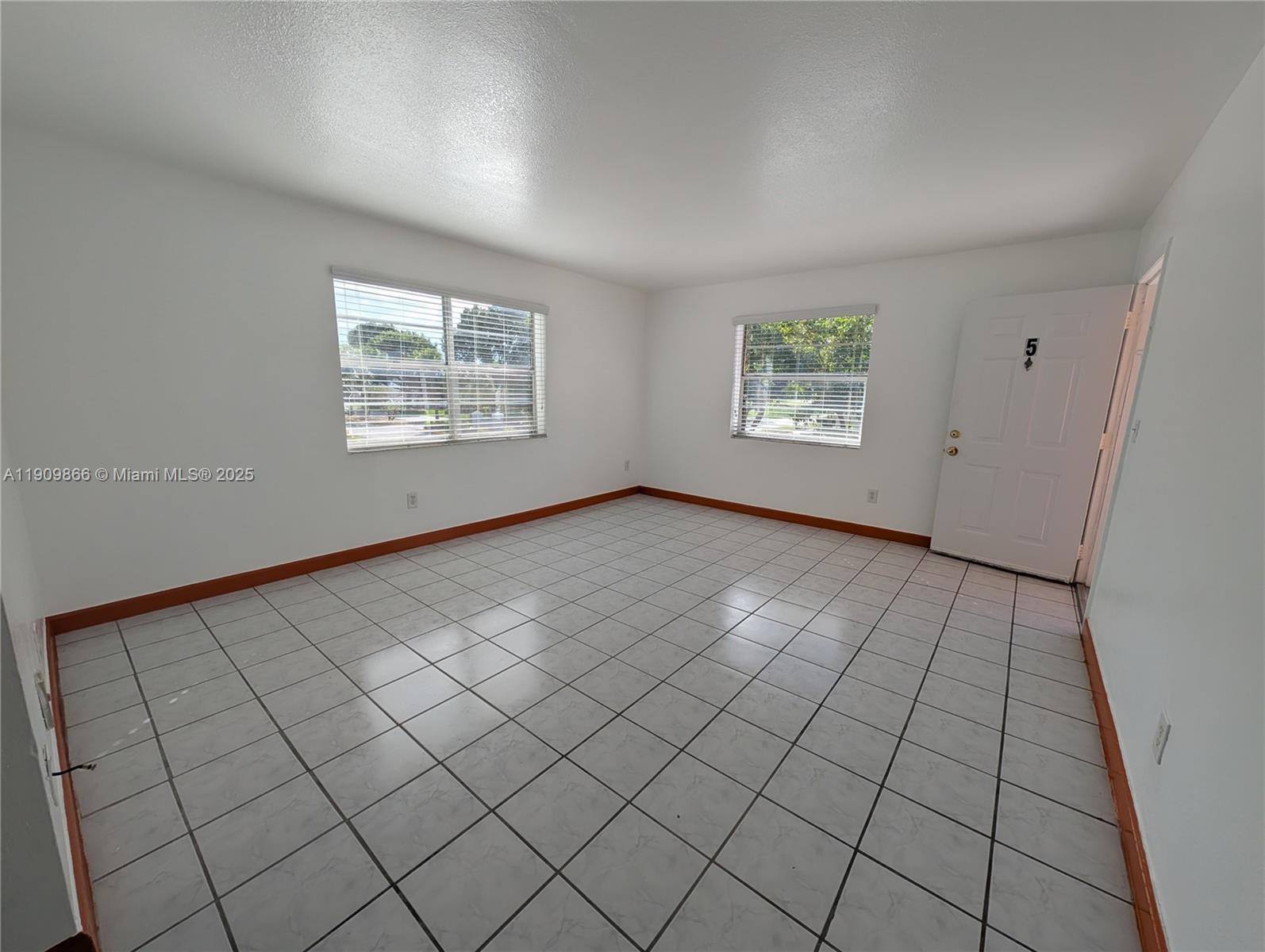1551 Northeast 8th Street, Unit 5 Homestead, FL 33033 - Photo 2 of 8 an empty room with windows