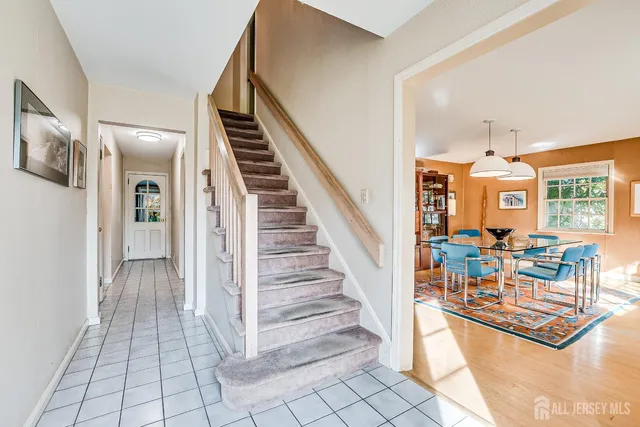 a living room with furniture fireplace and a large window