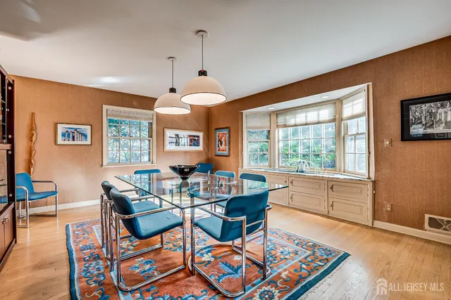 a living room with furniture a rug and a large window