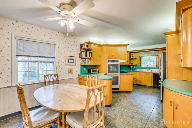 a kitchen with stainless steel appliances granite countertop a sink and a refrigerator