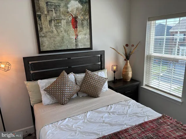 a bedroom with a bed and window