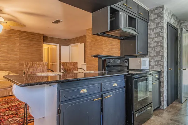 a kitchen with stainless steel appliances granite countertop a sink stove and cabinets