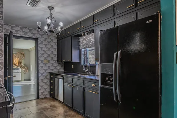 a kitchen with a refrigerator and a sink