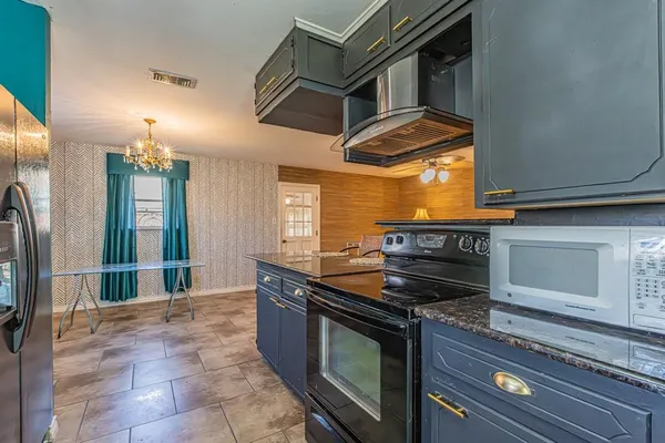 a kitchen with a stove and a microwave