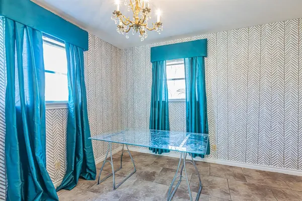 a view of a big room with wooden floor and a chandelier fan