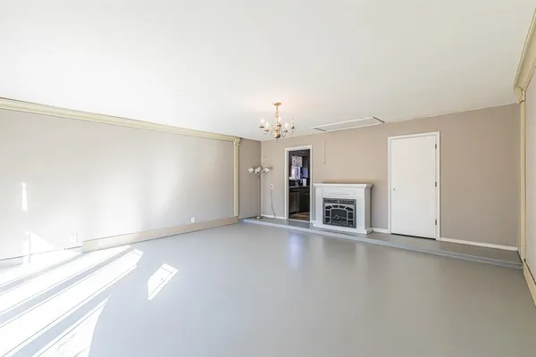 an empty room with windows and entrance