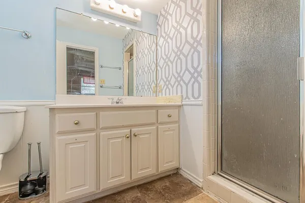 a bathroom with a sink a toilet and mirror