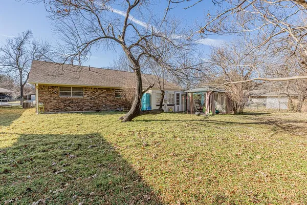 a view of a house with a yard covered in snow