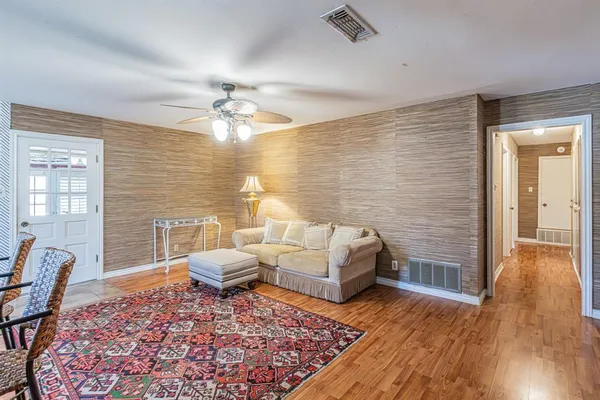 a living room with furniture and wooden floor