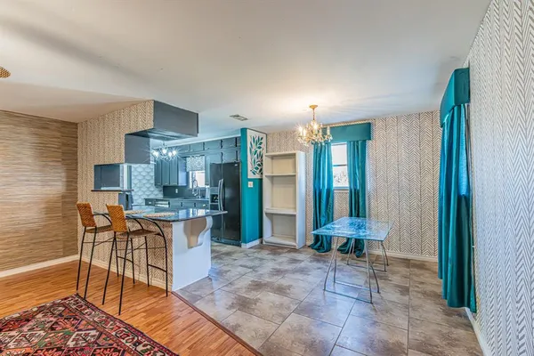 a large kitchen with a table and chairs in it