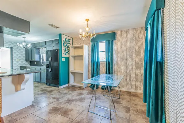 a view of a hallway with furniture and a chandelier