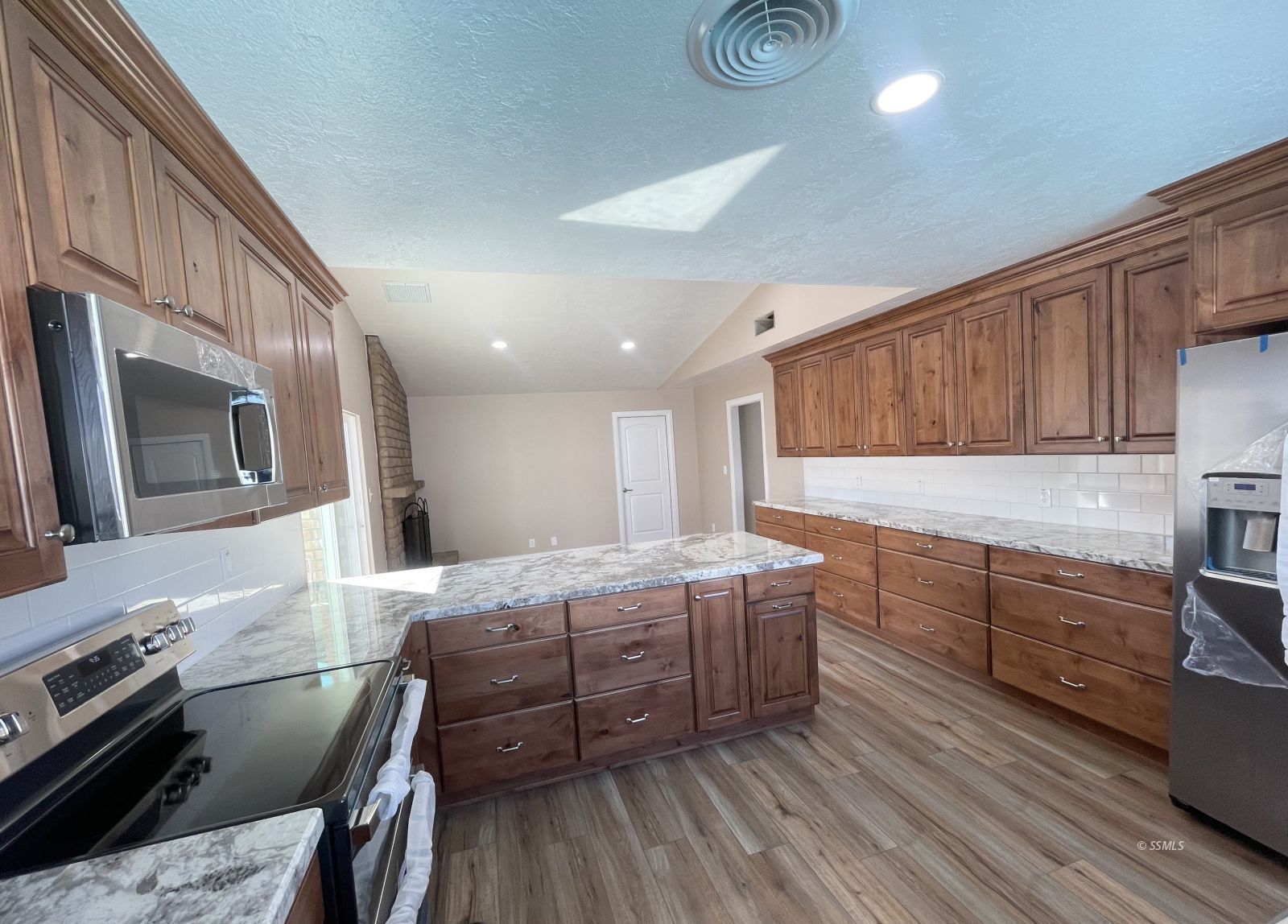 1031 North Sierra View Street Ridgecrest, CA 93555 - Photo 7 of 33 a kitchen with stainless steel appliances granite countertop a stove top oven a sink with granite countertops and cabinets