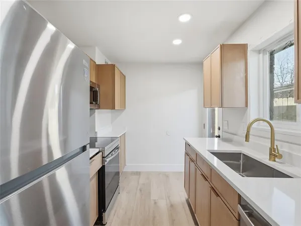 a kitchen with a sink and large window