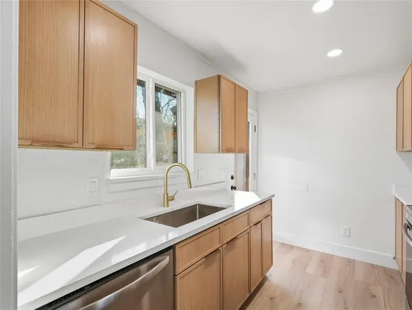 a kitchen with stainless steel appliances a refrigerator stove and sink