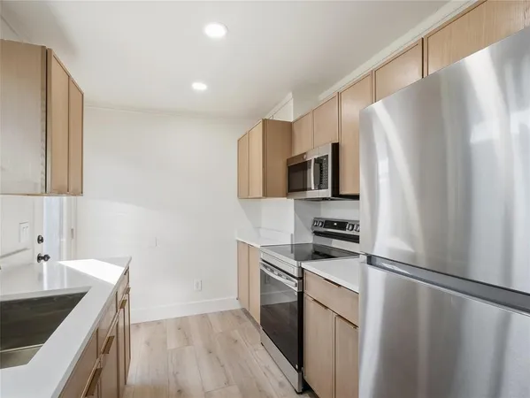 a kitchen with a sink and a refrigerator