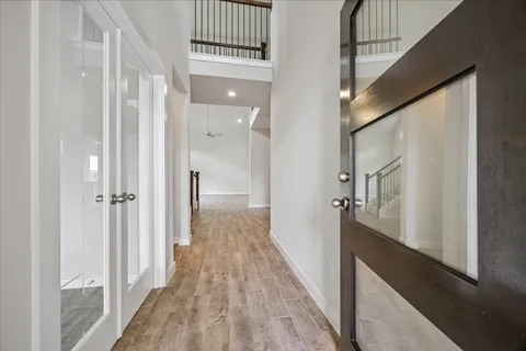 a view of hallway with wooden floor