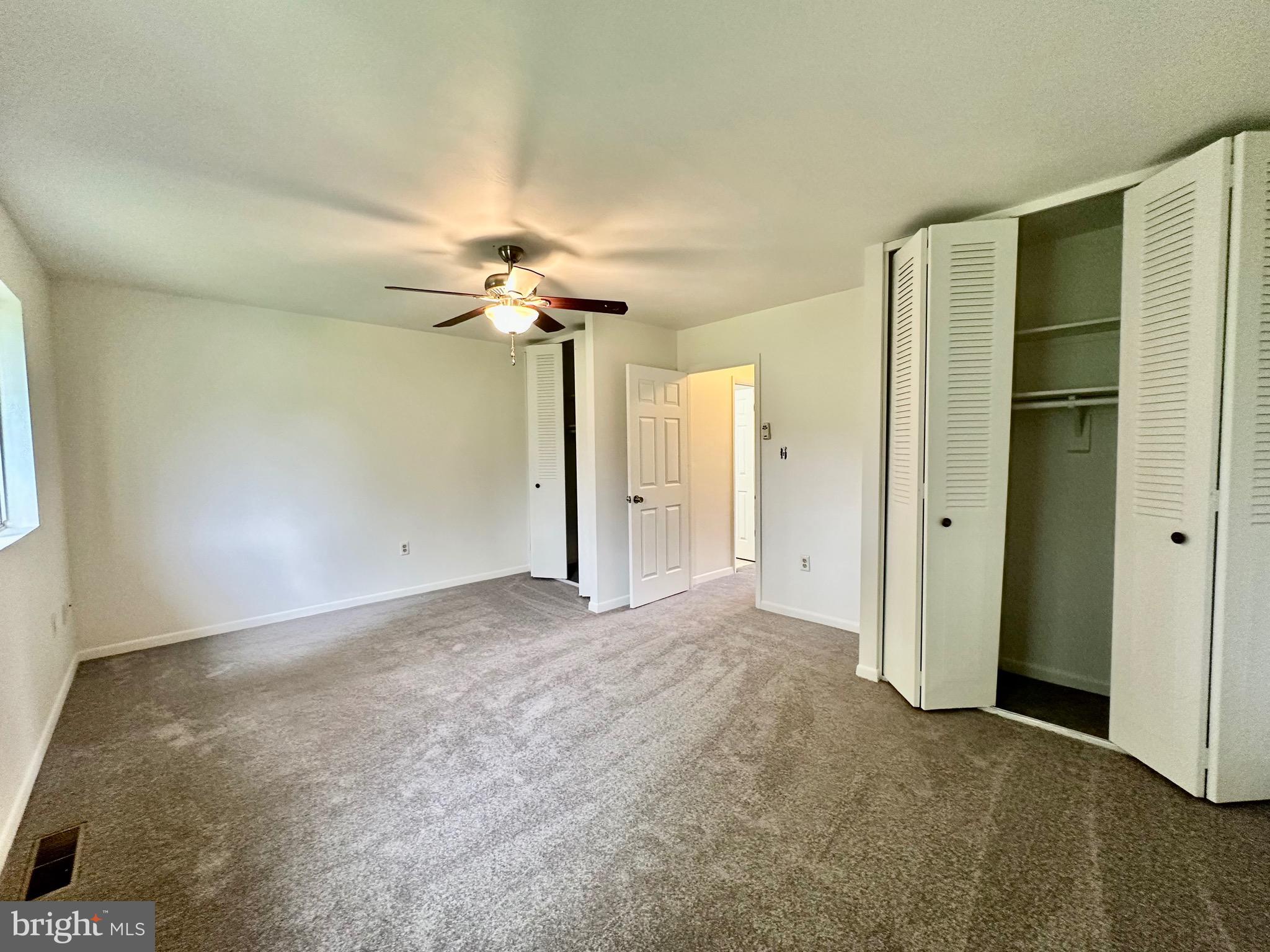 302 Hills Drive Gettysburg, PA 17325 - Photo 11 of 17 an empty room with a fan & a chandelier fan