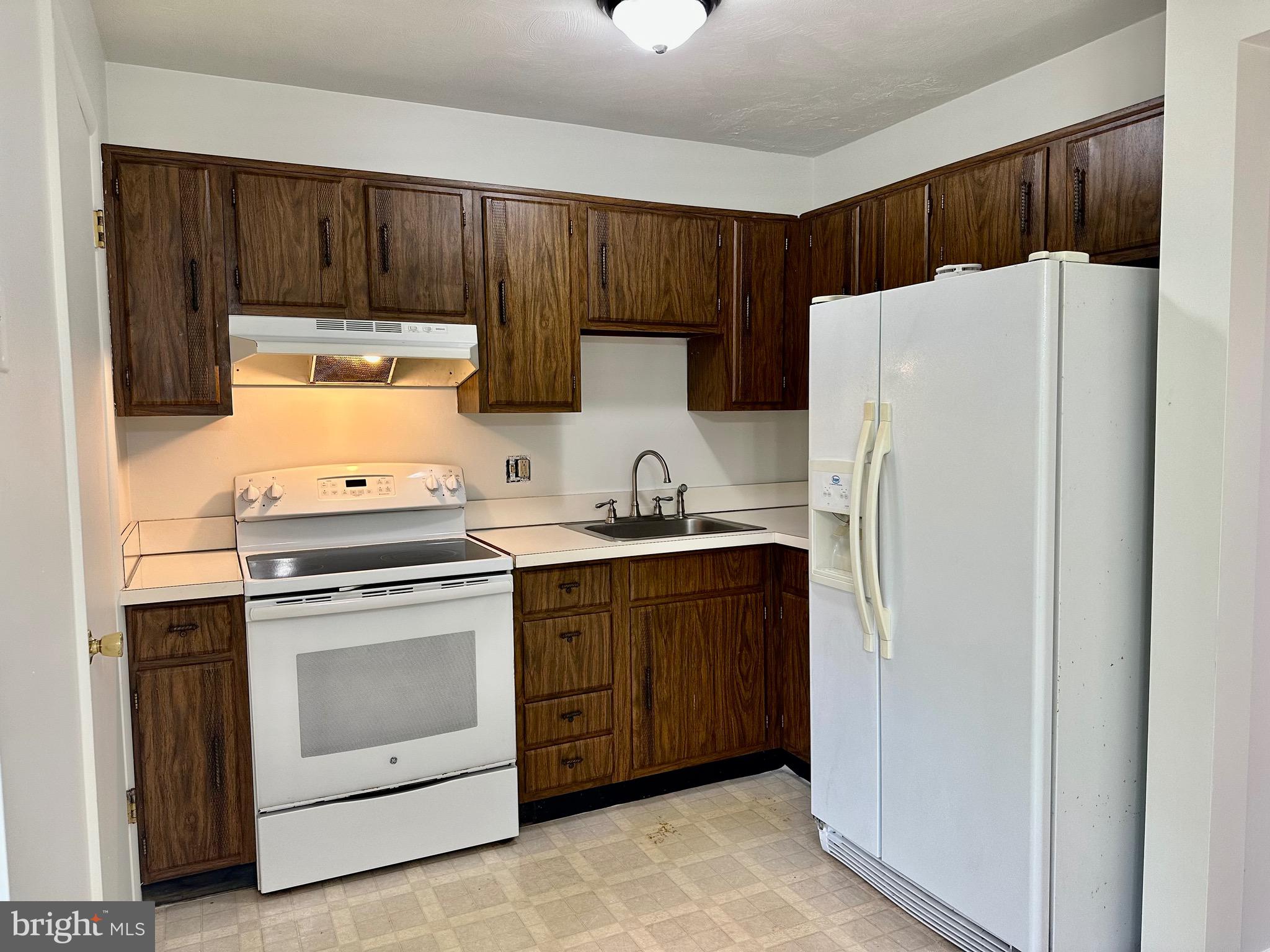 302 Hills Drive Gettysburg, PA 17325 - Photo 5 of 17 a kitchen with stainless steel appliances a stove and a refrigerator with cabinets