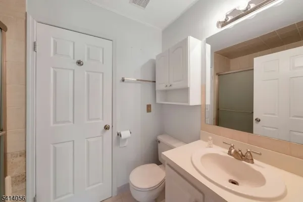 a bathroom with a granite countertop shower and a sink