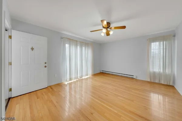 a view of empty room with ceiling fan