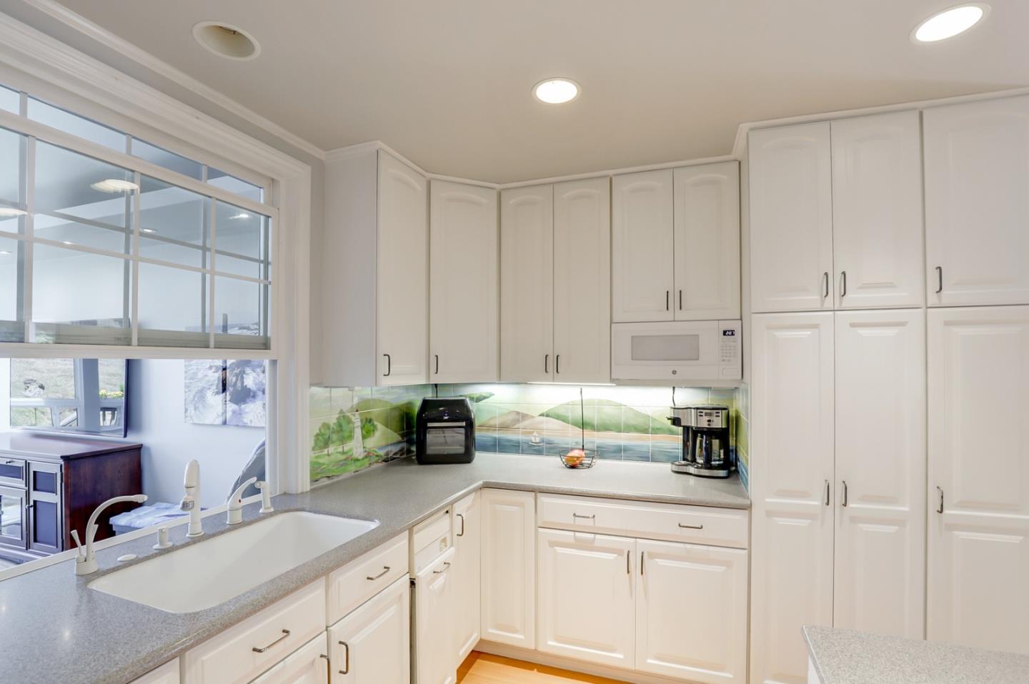 7840 Stage Road San Gregorio, CA 94074 - Photo 12 of 42 a kitchen with stainless steel appliances white cabinets and a sink