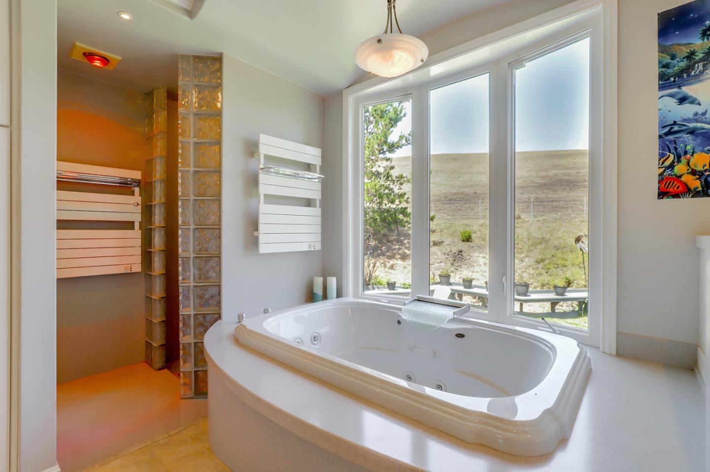 7840 Stage Road San Gregorio, CA 94074 - Photo 21 of 42 a bath tub sitting in a bathroom next to a window