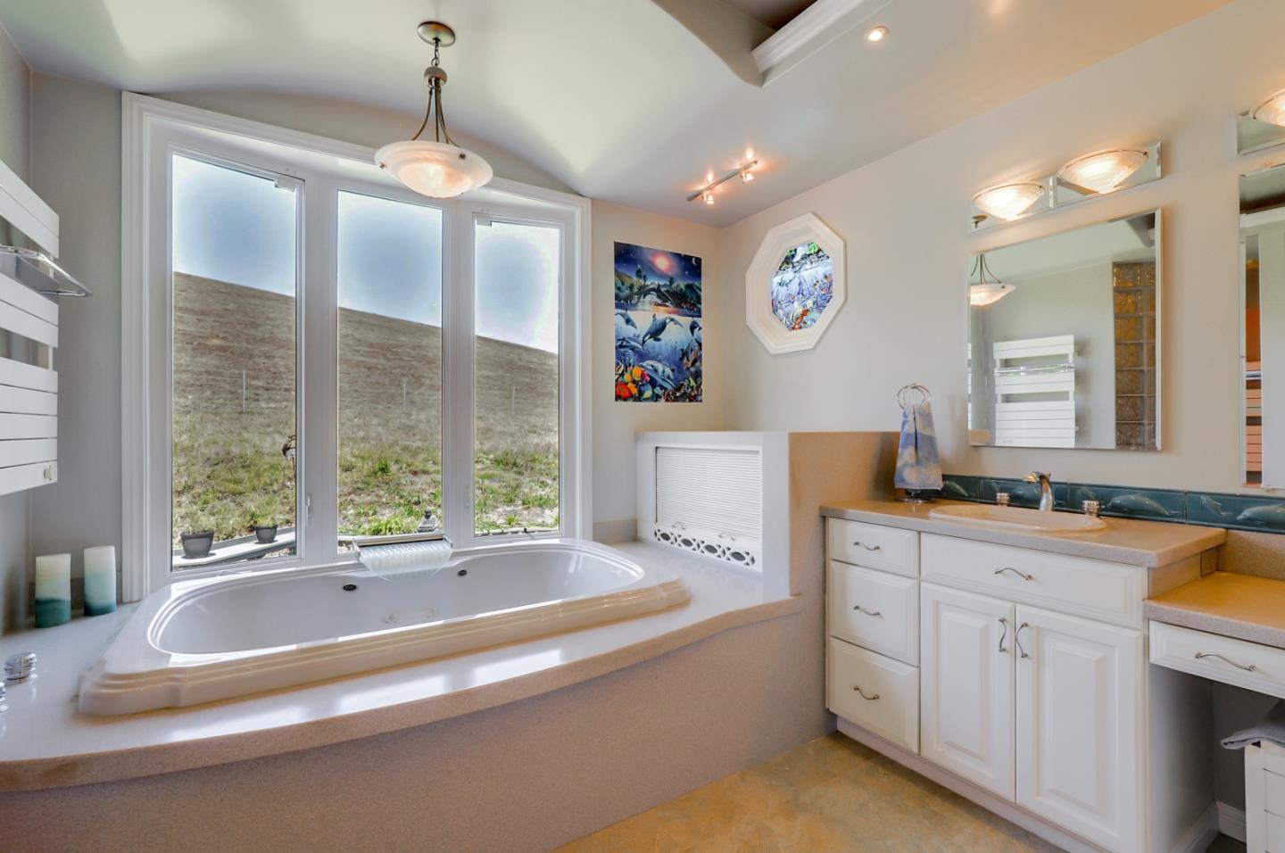 7840 Stage Road San Gregorio, CA 94074 - Photo 22 of 42 a spacious bathroom with a tub double vanity sink and a mirror
