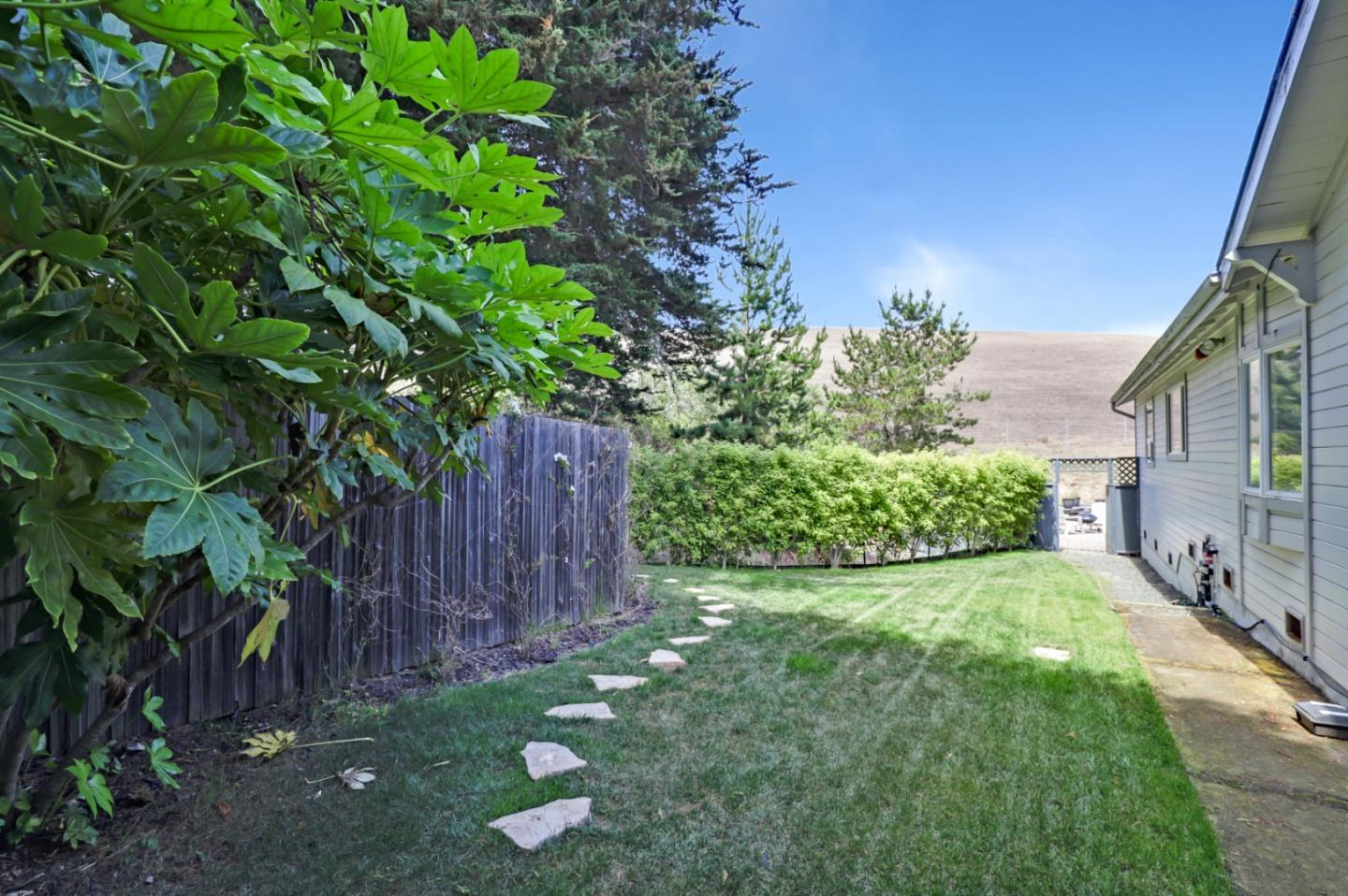 7840 Stage Road San Gregorio, CA 94074 - Photo 25 of 42 a view of a backyard with potted plants and wooden fence