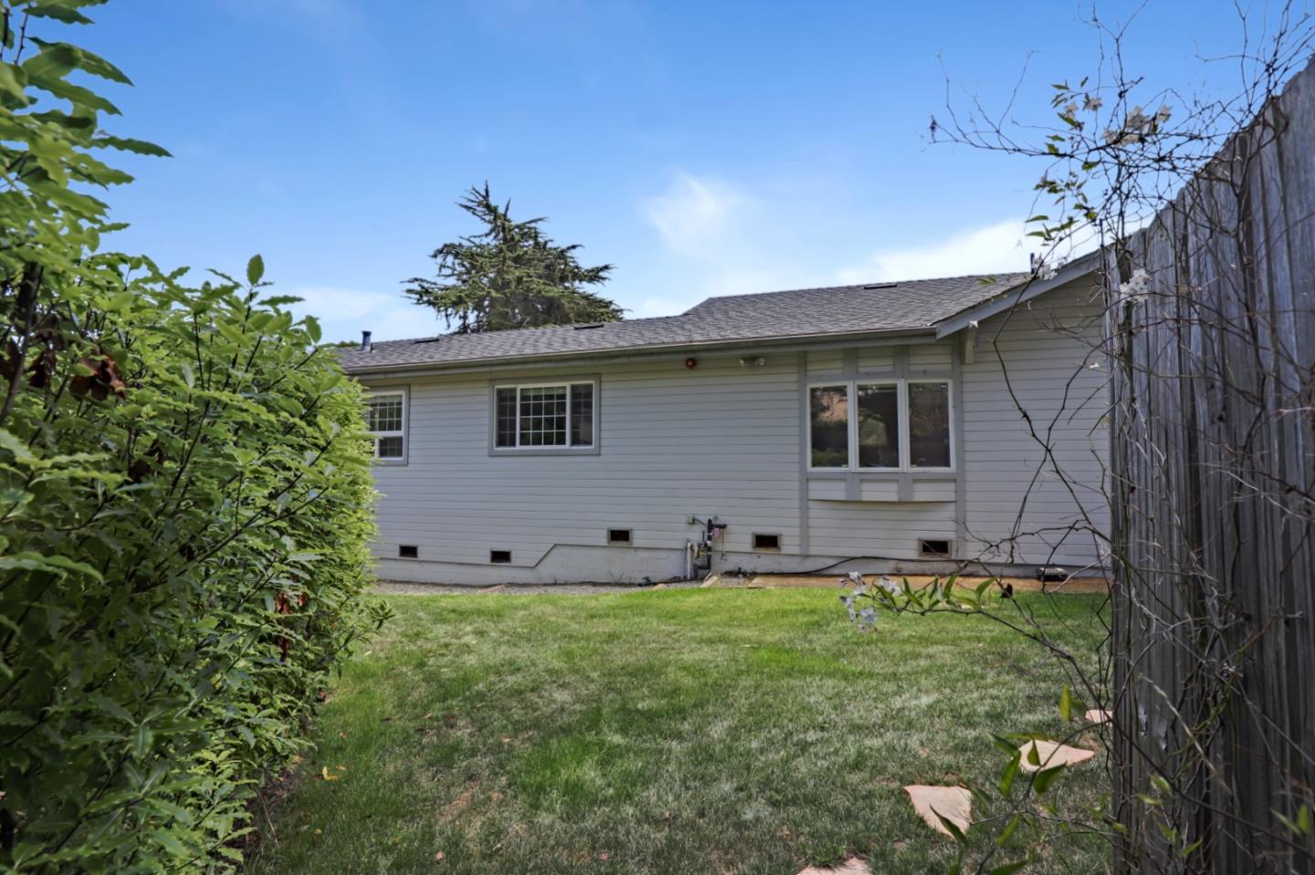 7840 Stage Road San Gregorio, CA 94074 - Photo 33 of 42 a front view of a house with a garden and yard