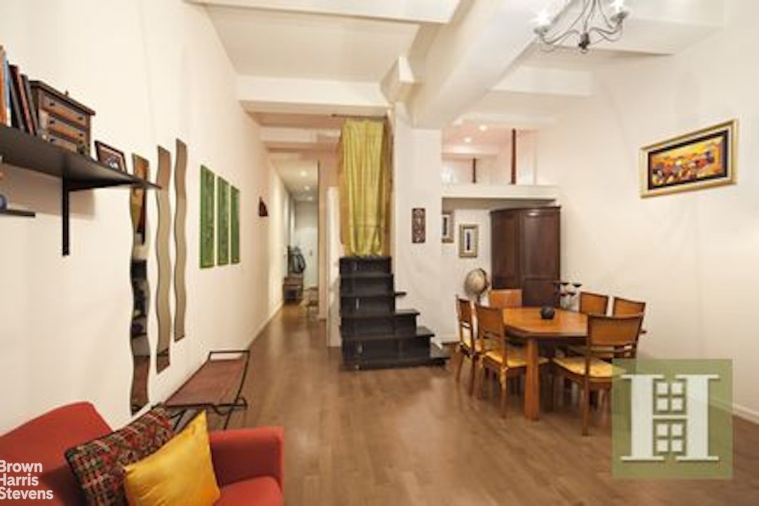 310 East 46th Street, Unit 4N Manhattan, NY 10017 - Photo 2 of 21 a living room with furniture and a chandelier