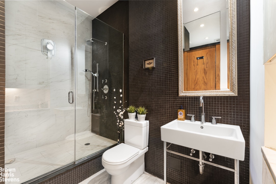 310 East 46th Street, Unit 4N Manhattan, NY 10017 - Photo 5 of 21 a bathroom with a sink toilet and shower