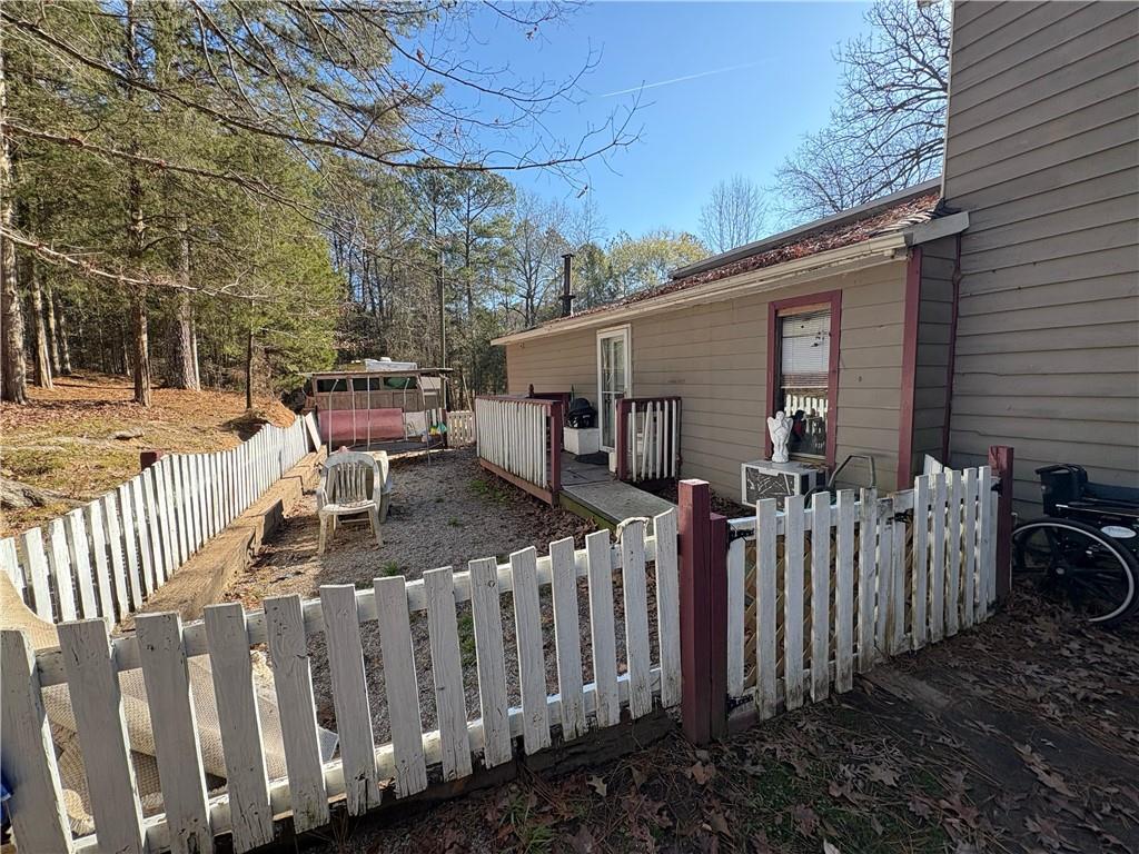 4750 Ridgewood Road Monroe, GA 30656 - Photo 17 of 23 a view of a house with backyard and wooden fence