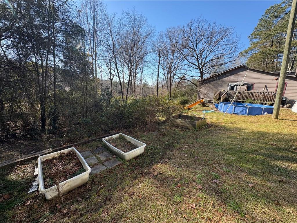 4750 Ridgewood Road Monroe, GA 30656 - Photo 18 of 23 a view of a backyard with table and chairs and a fire pit