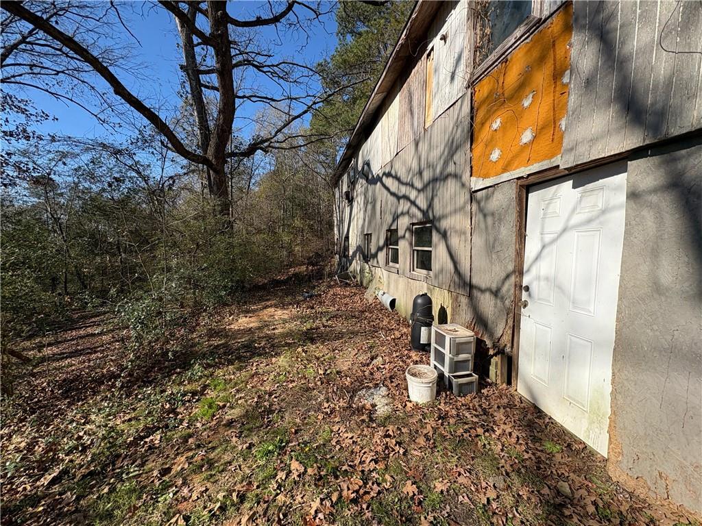 4750 Ridgewood Road Monroe, GA 30656 - Photo 19 of 23 a backyard of a house with lots of green space and wooden fence