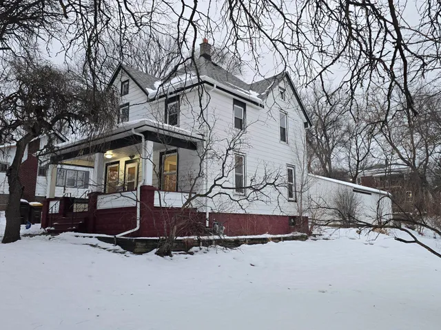 a view of a house with a yard covered in snow