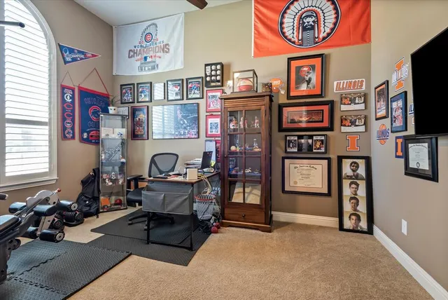 a living room with furniture a flat screen tv and a wall painting
