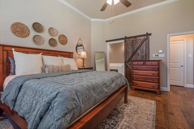 a bedroom with a bed and a chandelier