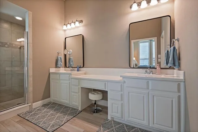 a bathroom with a sink vanity and a mirror