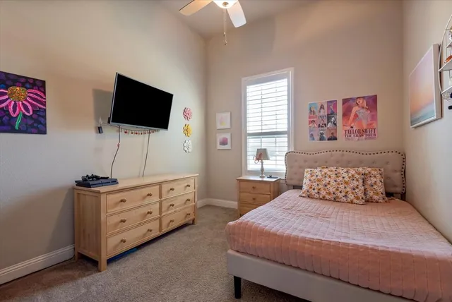 a bedroom with a bed and flat screen tv